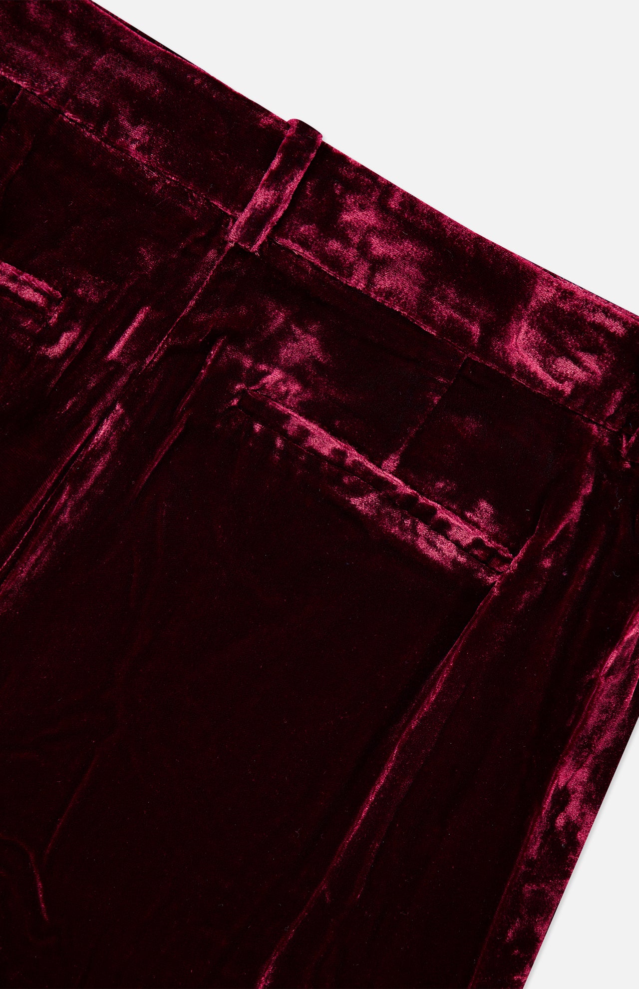 Close-up of the high-rise waistband and back pockets of the deep red L’Agence Pilar Wide Leg Velvet Trouser.