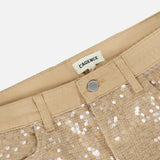 Close-up of Quincy Sequin High Rise Wide Leg Pant by L’AGENCE, featuring gold sequins, metal button, belt loops, and a label inside the waistband.