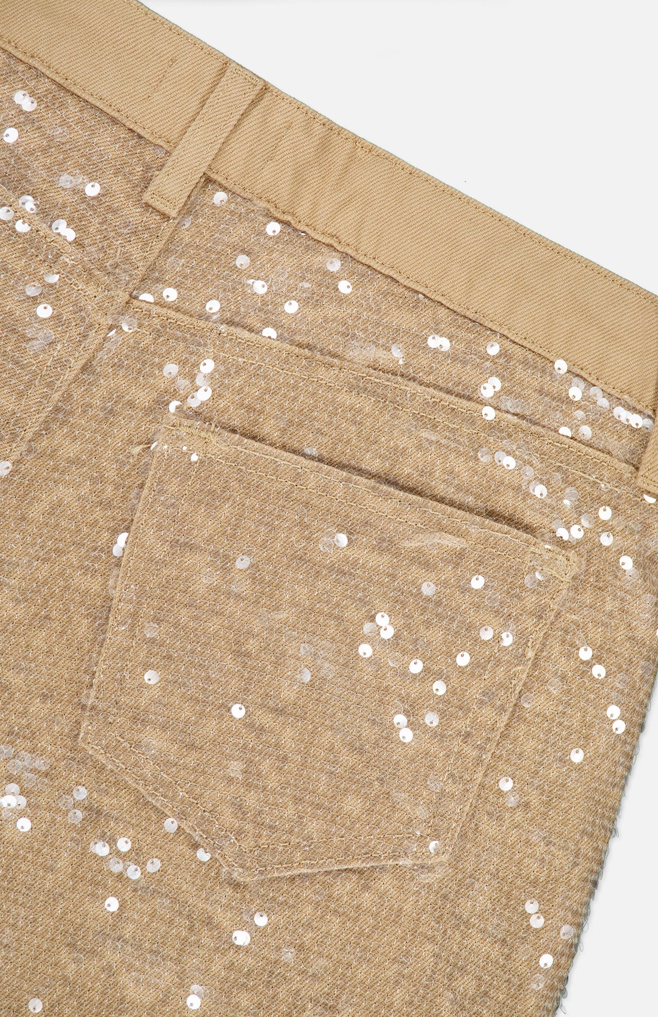 Close-up of the back pocket and waistband of the Quincy Sequin High Rise Wide Leg Pant by L’AGENCE, featuring tan fabric adorned with silver sequins for a sparkling, textured look.