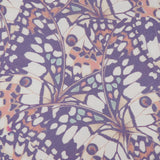 The Ressi Short Sleeve Crewneck Butterfly T-Shirt by L'AGENCE features a vibrant, symmetrical butterfly wing pattern with purple, white, orange, and light green spots. Slim fit. Made in the USA for comfort and style.