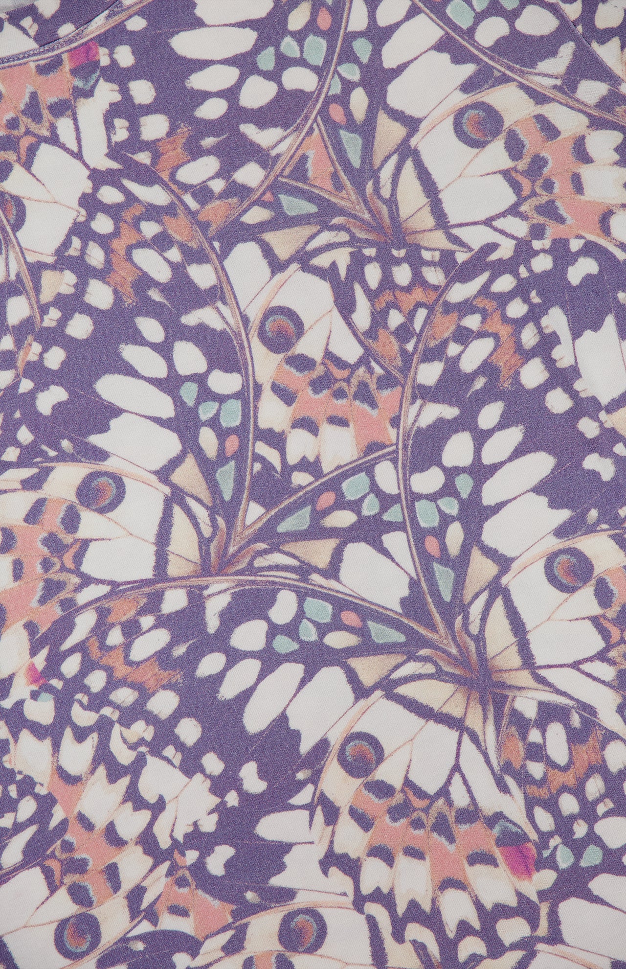 The Ressi Short Sleeve Crewneck Butterfly T-Shirt by L'AGENCE features a vibrant, symmetrical butterfly wing pattern with purple, white, orange, and light green spots. Slim fit. Made in the USA for comfort and style.