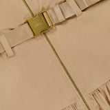 Close-up of the L'AGENCE Rima Belted Maxi Dress in light brown, showcasing a gold zipper, matching beige fabric belt with gold buckle, and gathered hem detail.