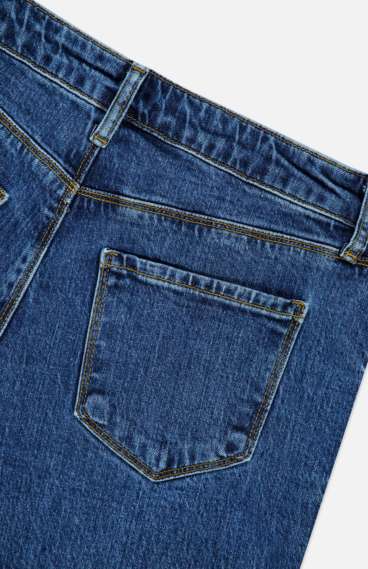 Close-up of the back pocket and waistband of the Ruth High Rise Straight Jean in Newcastle by L’AGENCE, crafted from blue premium stretch denim, featuring detailed stitching and a single belt loop, isolated on a white background.