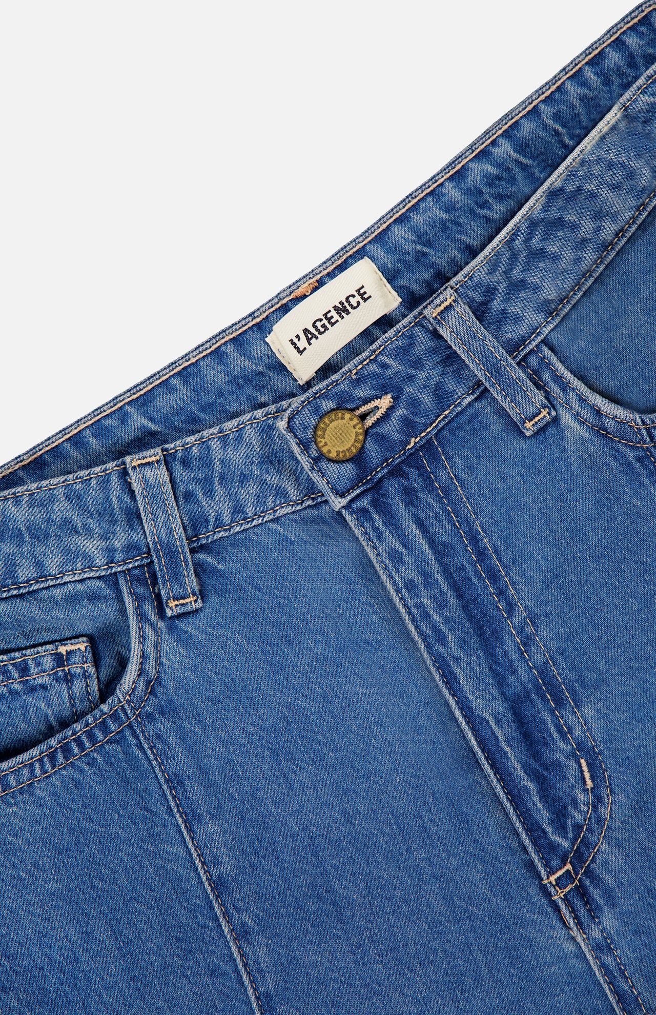 Close-up of the top section of L'AGENCE Sandy High Rise Wide Leg Jean in Wilton, featuring visible belt loops, button closure, front pockets, and a contoured waistband with a white PAGENCE label.