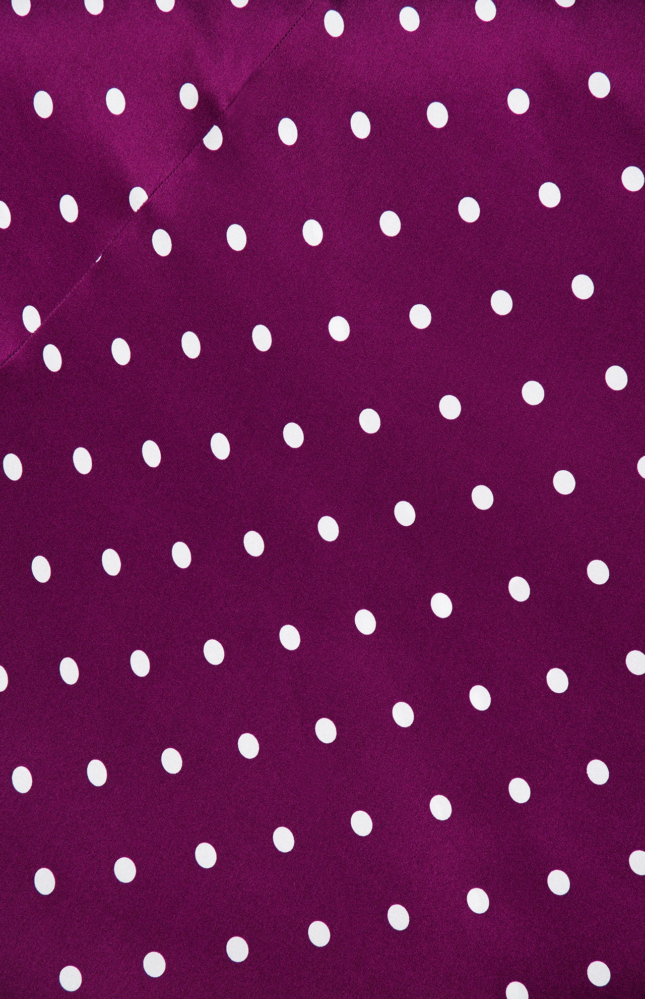 L’Agence Sayla Bias Cut Maxi Dress in deep purple fabric with a white polka dot pattern.