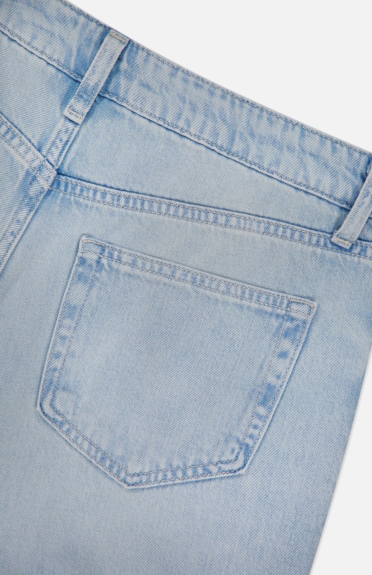 Close-up of the back pocket and waistband of the Scottie High Rise Wide Leg Jean in Lago by L'AGENCE, highlighting stitching details and a belt loop against a white background.