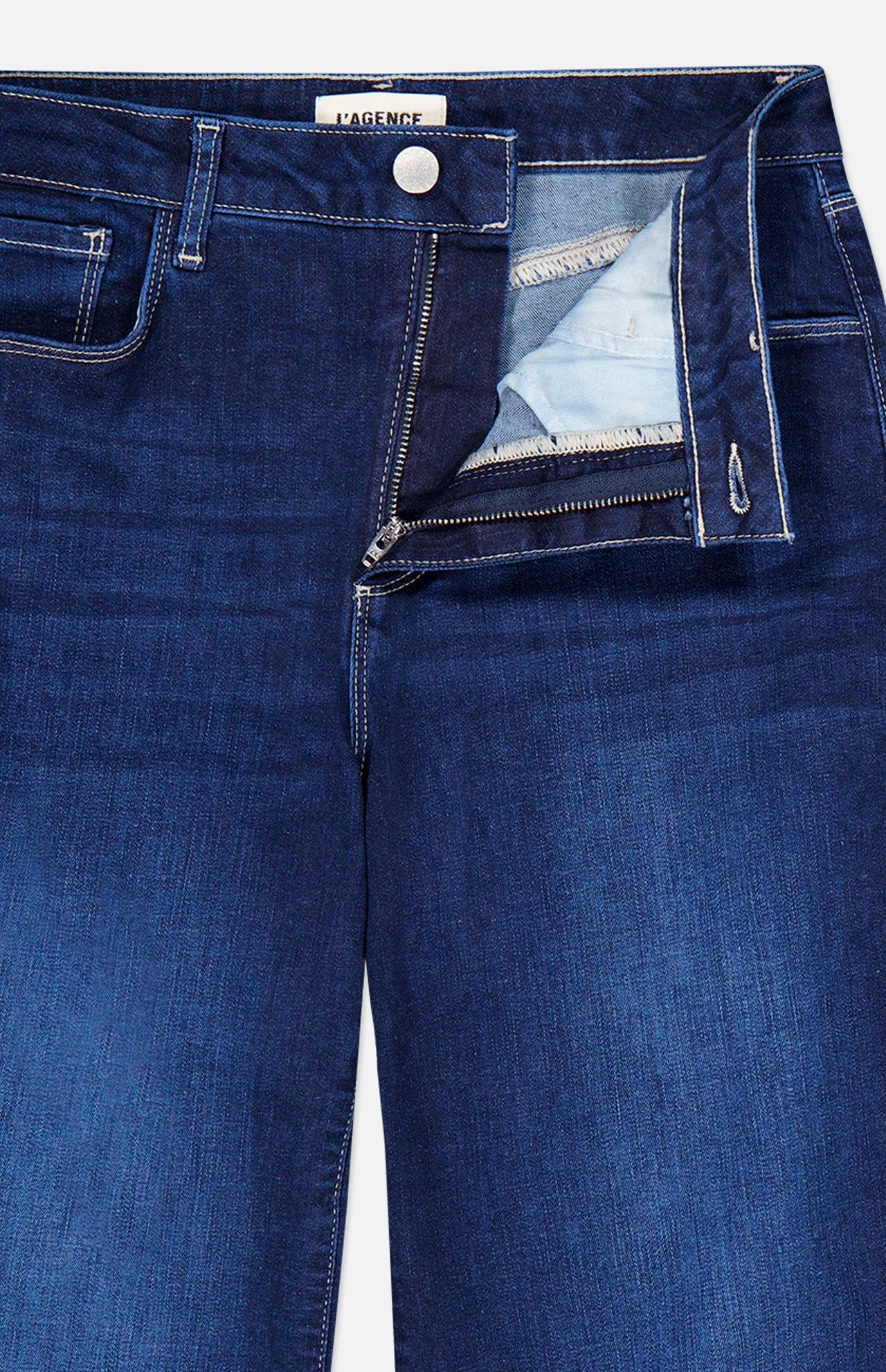 Close-up of the L’Agence Scottie High Rise Wide Leg Jean in Robles, featuring a dark blue wide-leg design with the fly unzipped.