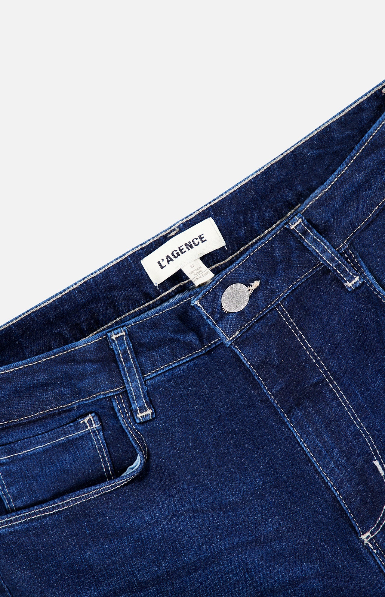 Close-up of the waistband and button fly of L’Agence Scottie High Rise Wide Leg Jean in Robles dark blue denim.