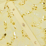 Close-up of the L'AGENCE Seychelle Cropped Button Down Shirt—a yellow summer top with floral embroidery, shiny buttons, a pointed collar, and semi-sheer eyelet fabric for a delicate, feminine look.