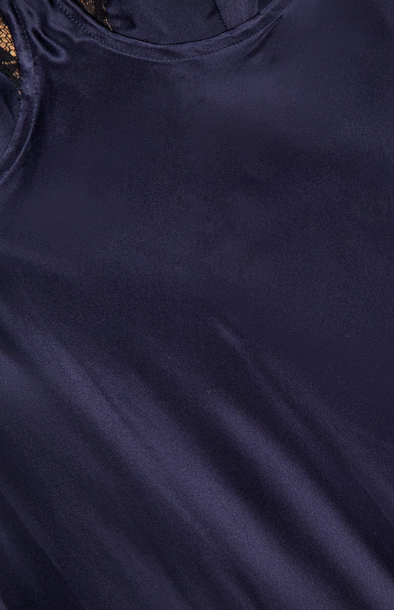 Close-up of silky, dark blue fabric with smooth texture and sheen, featuring stitching and lace details from the top edge of the Shayla Lace Bias Cut Maxi Dress by L'AGENCE.
