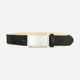 Showcased on a plain white background, the Solera Engraved Plaque Belt by L’AGENCE features a refined black leather strap and a large, ornate silver rectangular buckle with decorative engravings along the edges. Drawing inspiration from classic silver accessories and the luxurious texture of Italian calf hair, this elegant accessory exudes timeless sophistication.