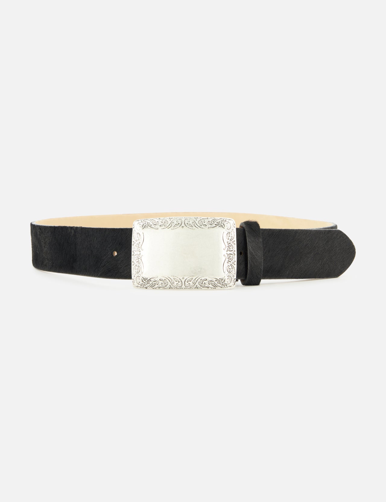 Showcased on a plain white background, the Solera Engraved Plaque Belt by L’AGENCE features a refined black leather strap and a large, ornate silver rectangular buckle with decorative engravings along the edges. Drawing inspiration from classic silver accessories and the luxurious texture of Italian calf hair, this elegant accessory exudes timeless sophistication.
