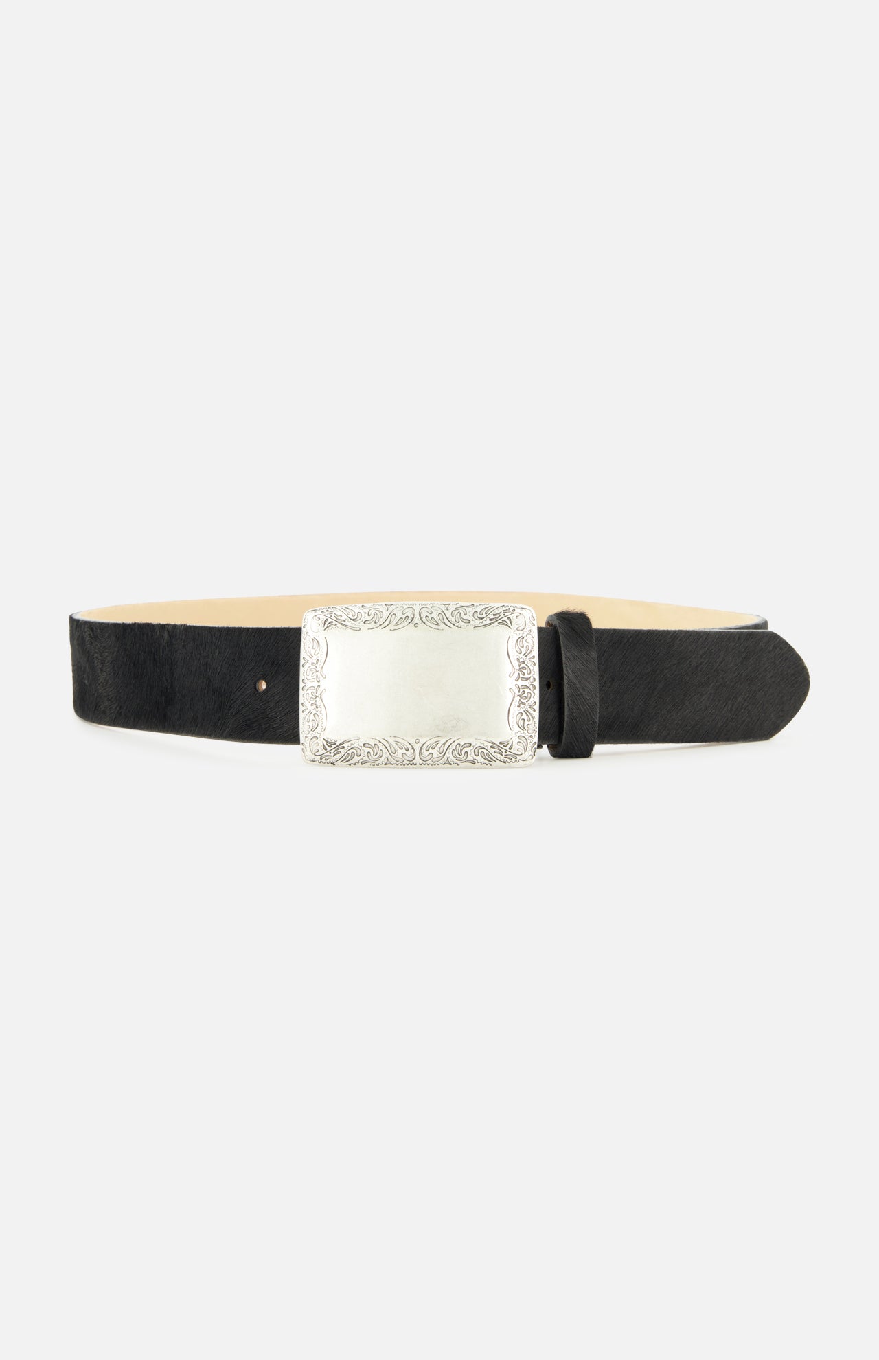 Showcased on a plain white background, the Solera Engraved Plaque Belt by L’AGENCE features a refined black leather strap and a large, ornate silver rectangular buckle with decorative engravings along the edges. Drawing inspiration from classic silver accessories and the luxurious texture of Italian calf hair, this elegant accessory exudes timeless sophistication.