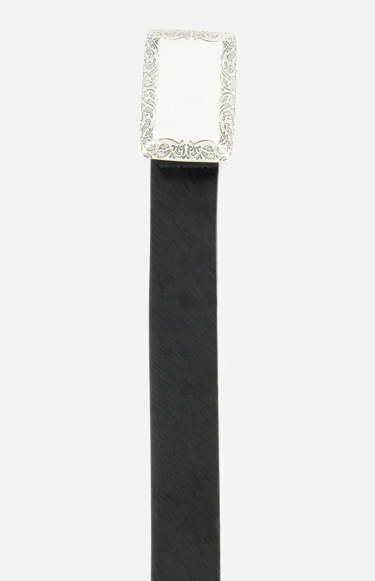 Introducing the Solera Engraved Plaque Belt by L’AGENCE—a sophisticated black leather belt crafted from luxurious Italian calf hair. This elegant accessory features a rectangular, ornate silver buckle with intricate engraved details along the edges, making it the perfect pairing for your favorite silver pieces. Photographed against a plain white background, this belt adds a touch of refined style to any ensemble.