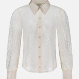 The Sophie Long Sleeve Blouse by L'AGENCE is an off-white, sheer blouse with a pointed collar, beige button front and cuffs, plus long sleeves featuring a delicate dotted pattern for subtle texture.