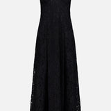 The Sutton Lace Maxi Dress by L’AGENCE is a sleeveless black maxi dress crafted from heavyweight lace fabric, featuring a fitted bodice, wide shoulder straps, and a flared skirt. Displayed on a plain white background, this elegant dress is perfect for any special occasion.