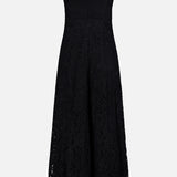 The Sutton Lace Maxi Dress by L’AGENCE features a sleeveless silhouette in black heavyweight lace with an allover floral pattern, a fitted bodice with square neckline, frayed trim on the straps, wide-leg design, and a back zip closure.
