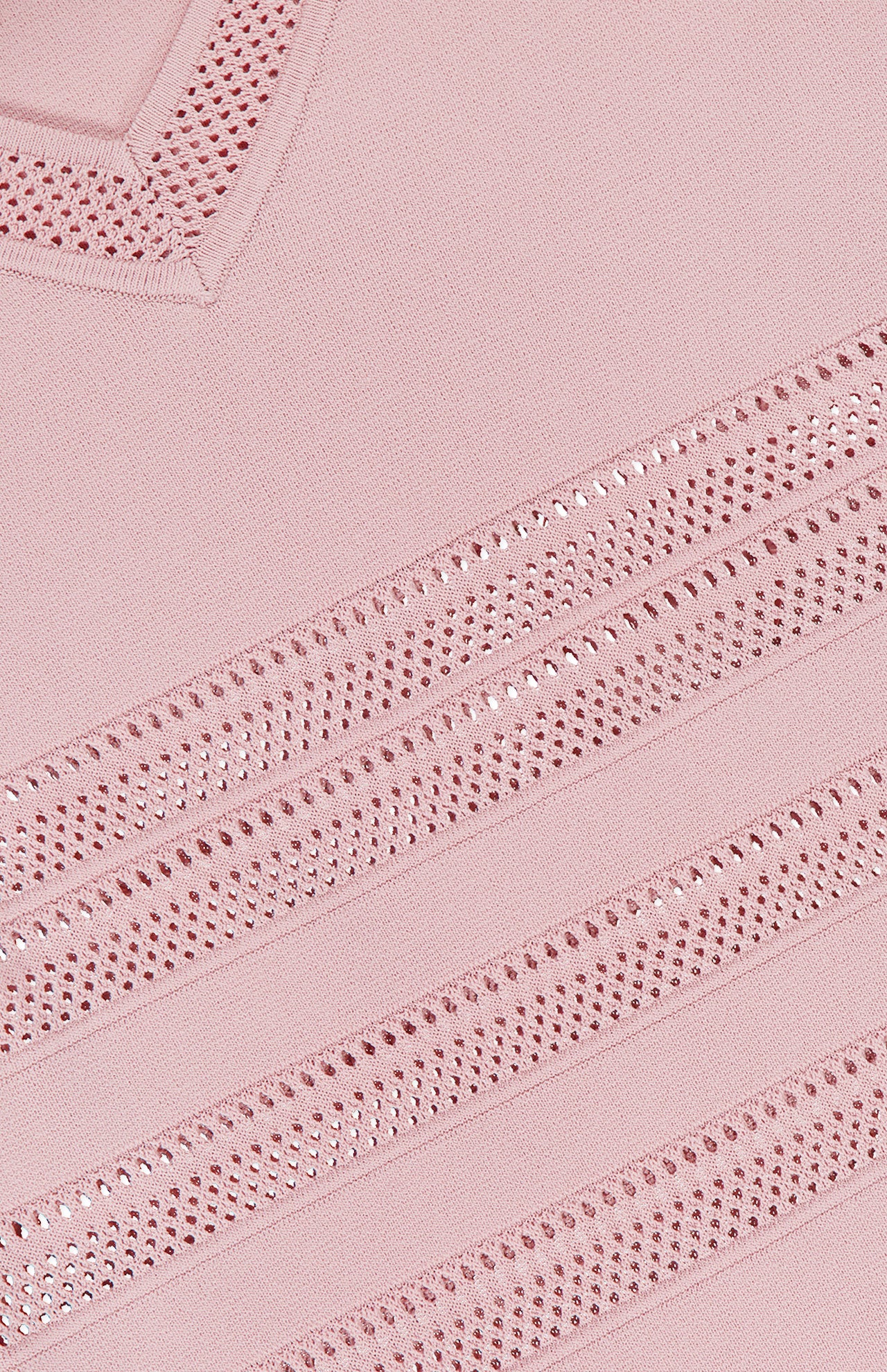 Close-up of the Taren Knit Midi Dress by L'AGENCE, showing light pink power knit fabric with diagonal open-knit mesh and solid patterns, featuring textured stitching and a ribbed edge for a subtle compression effect.