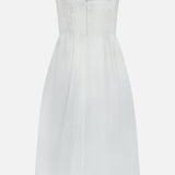 The Tiani Bustier Midi Dress by L'AGENCE features white linen, wide straps, a smocked bodice, and a flared midi skirt with a back zipper and button—perfect for effortless summer style.