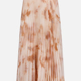 The L’AGENCE Torin Pleated Maxi Skirt features a soft peach and beige frappe tie-dye on lightweight fabric, shown against a plain white background.