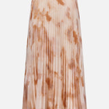 The L’AGENCE Torin Pleated Maxi Skirt features a light beige base with a brown frappe tie-dye pattern and is shown against a plain white background.