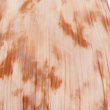 A close-up of the L'AGENCE Torin Pleated Maxi Skirt, crafted from soft, slightly glossy fabric with evenly spaced vertical pleats and a peach, beige, and light brown frappe tie-dye pattern.