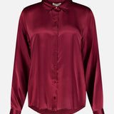 The Tyler Long Sleeve Silk Blouse by L’AGENCE is crafted in luxurious silk with a classic collar, button-up front, and a rich merlot red hue that gives it a smooth, lustrous finish.