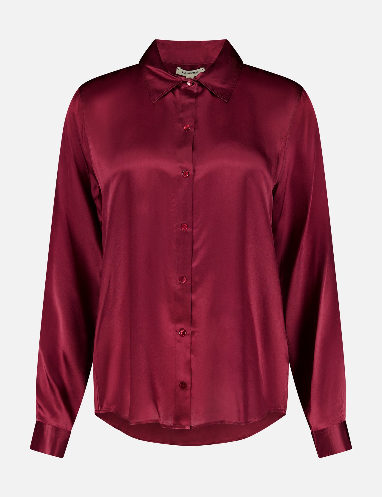 The Tyler Long Sleeve Silk Blouse by L’AGENCE is crafted in luxurious silk with a classic collar, button-up front, and a rich merlot red hue that gives it a smooth, lustrous finish.