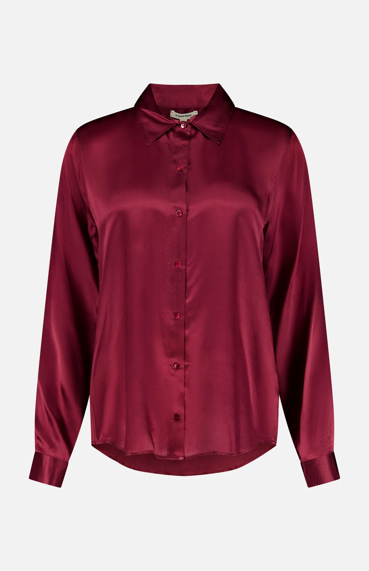 The Tyler Long Sleeve Silk Blouse by L’AGENCE is crafted in luxurious silk with a classic collar, button-up front, and a rich merlot red hue that gives it a smooth, lustrous finish.