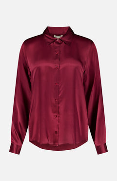 The Tyler Long Sleeve Silk Blouse by L’AGENCE is crafted in luxurious silk with a classic collar, button-up front, and a rich merlot red hue that gives it a smooth, lustrous finish.