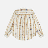 The Tyler Long Sleeve Belt Print Blouse by L’AGENCE is displayed from the back, showcasing its cream background adorned with vertical tan belts and blue buckles. This elegant silk button-down top offers a sophisticated twist on the classic ecru blouse.