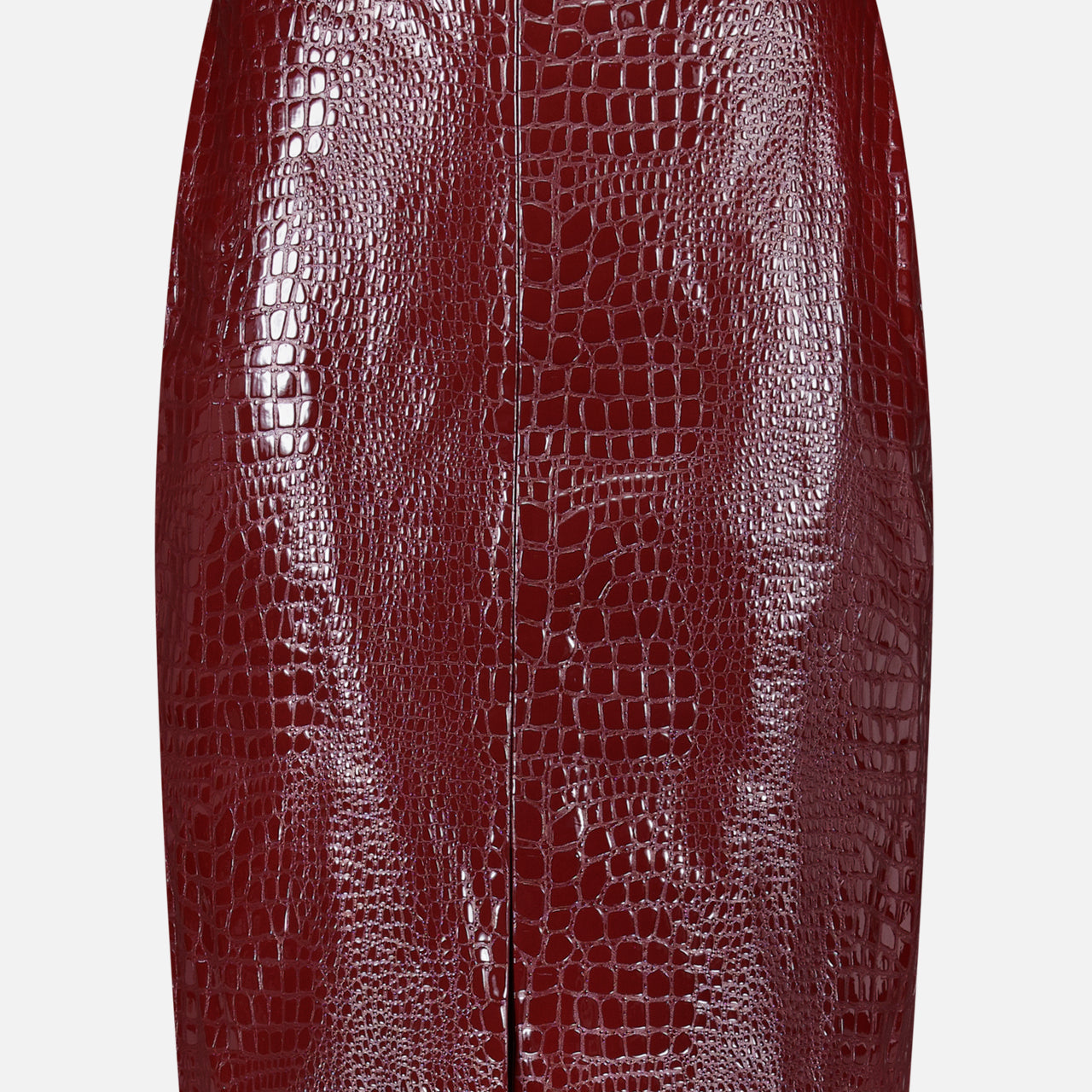 The Violetta Pencil Skirt by L’AGENCE, crafted from burgundy croc-embossed vegan leather, features a front seam and a subtle front slit, showcased against a plain white background.