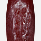 The Violetta Pencil Skirt by L’AGENCE is a shiny, dark red croc-embossed vegan leather mini skirt featuring a fitted silhouette and back zipper, displayed against a plain white background.
