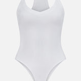 The Wrenna Racerback Bodysuit by L'AGENCE is a white fitted ribbed bodysuit with a V-neckline and racerback design, shown against a plain white background.
