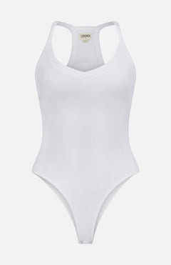 The Wrenna Racerback Bodysuit by L'AGENCE is a white fitted ribbed bodysuit with a V-neckline and racerback design, shown against a plain white background.