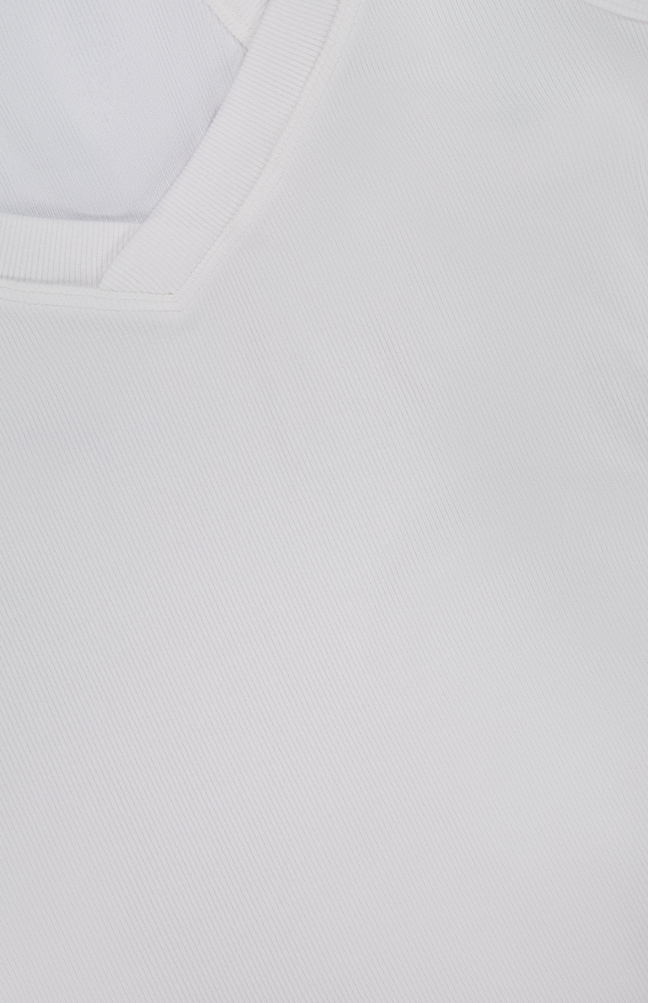 Close-up of the Wrenna Racerback Bodysuit by L'AGENCE, featuring a white hue, V-neck collar, and fine fabric texture.