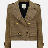 The Xoey Cropped Plaid Trench Coat by L'AGENCE is a brown and black houndstooth blazer featuring gold buttons, wide lapels, shoulder epaulets, and cuff straps. Reminiscent of a double-breasted jacket, this striking plaid style includes a label inside the collar that reads L'AGENCE.