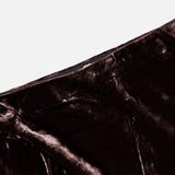 Close-up of a dark brown L’Agence Zeta Long Velvet Skirt featuring a bias-cut design.