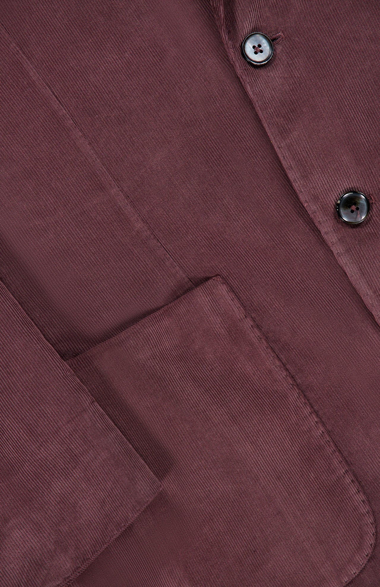 Close-up of the L.B.M. Corduroy Single Breasted Sportcoat in maroon, highlighting a front pocket, part of a sleeve, and two black buttons. The texture and fine ridges of the cotton corduroy fabric are clearly visible.