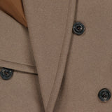 Close-up of the L.B.M. Double Breasted Car Coat in brown, featuring four black buttons and overlapping fabric lapels with a hint of lighter brown inner lining—an elegant Italian-made piece.