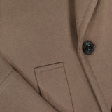 Close-up of the L.B.M. Double Breasted Car Coat in brown, crafted from a wool-blend and featuring two black buttons, sharp lapels, and a neatly stitched pocket. The fabric's texture and tailored details are clearly visible, highlighting the refined craftsmanship typical of Italian-made pieces.