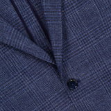 Close-up of the L.B.M. Glen Plaid 2 Button Sportcoat, expertly crafted from a luxurious wool-silk-linen blend, showcasing its textured navy blue glen plaid pattern, classic lapel, and two black buttons.