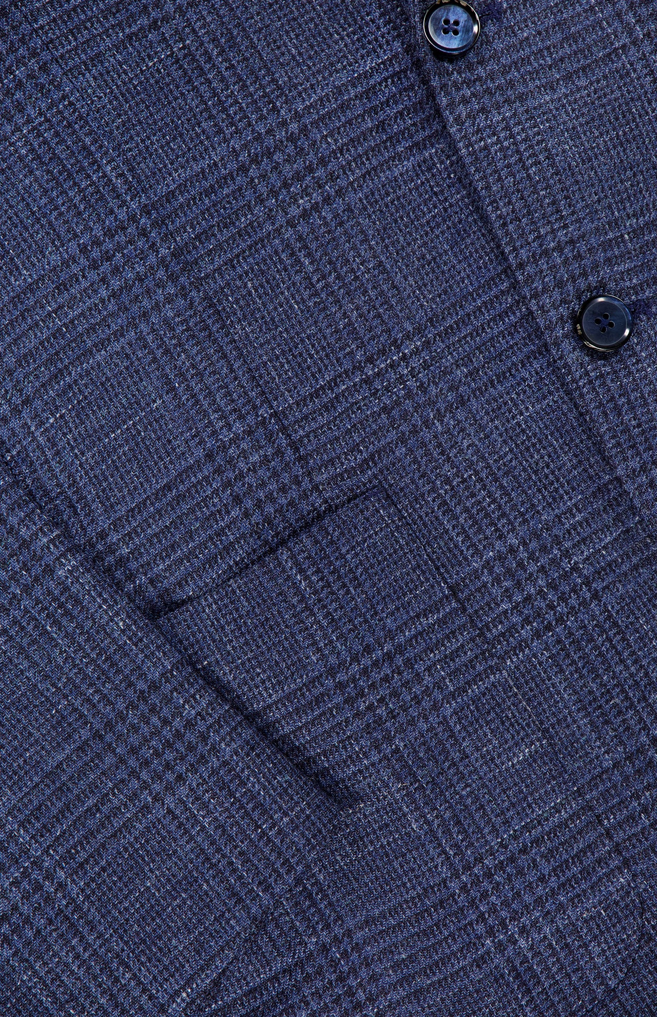 Close-up of the Glen Plaid 2 Button Sportcoat by L.B.M., featuring a blue plaid patterned fabric with two dark buttons visible.