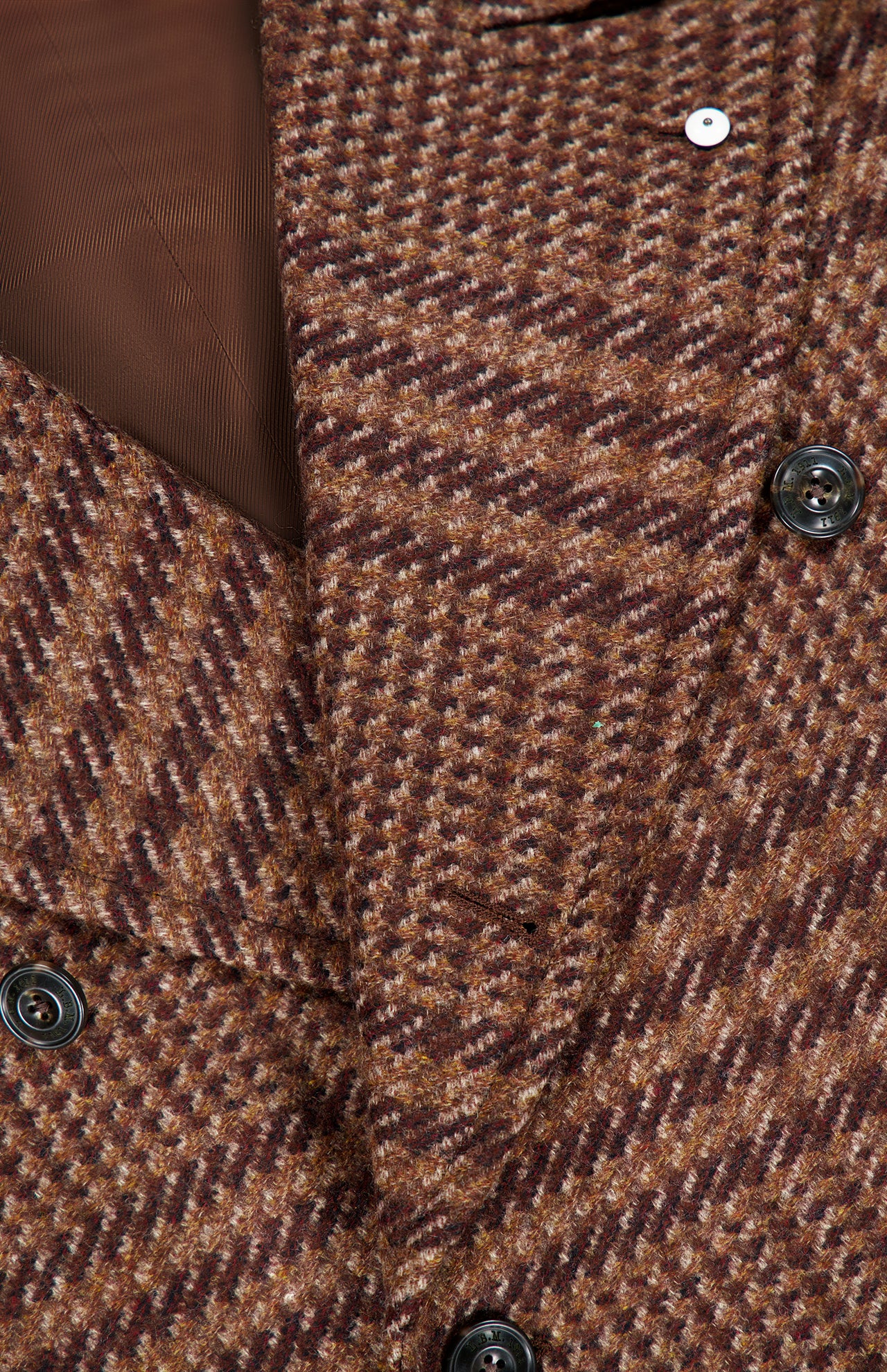 Close-up of the Glen Plaid Long Coat by L.B.M.: brown wool-blend, houndstooth pattern, black buttons, double-breasted style, and visible brown inner lining.