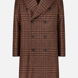 The Glen Plaid Long Coat by L.B.M. features a brown double-breasted wool blend design with black buttons, wide lapels, and two side pockets, showcased against a white background.