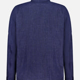 Back view of the Glen Plaid Overshirt by L.B.M., featuring a navy plaid pattern with a collar, long sleeves, and buttoned cuffs, displayed against a plain white background.