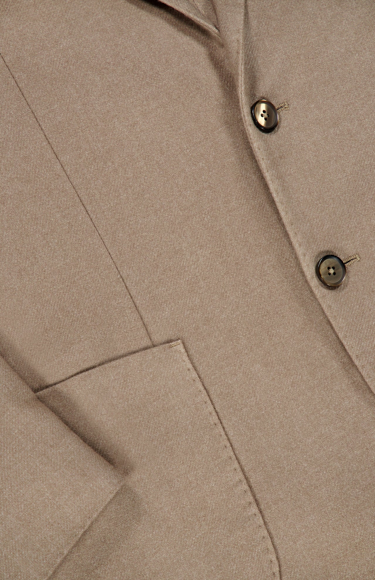 Close-up of the L.B.M. Solid 2 Button Sportcoat in beige, expertly crafted from wool and cashmere in Italy. The image highlights part of the lapel, two buttons, a pocket, and the sleeve with visible stitching and detailed fabric texture.