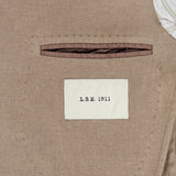 Close-up of the interior pocket of the Solid 2 Button Sportcoat by L.B.M., featuring a white label that reads L.B.M. 1911. A portion of striped fabric lining appears in the upper right corner, showcasing the refined craftsmanship of this wool cashmere blazer, expertly made in Italy.