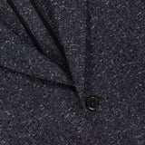 Close-up of the L.B.M. Speck 2 Button Sportcoat in textured dark grey, featuring two black buttons and a visible pocket. Fine speckled details highlight the expert Italian craftsmanship, making this an elegant and refined piece.