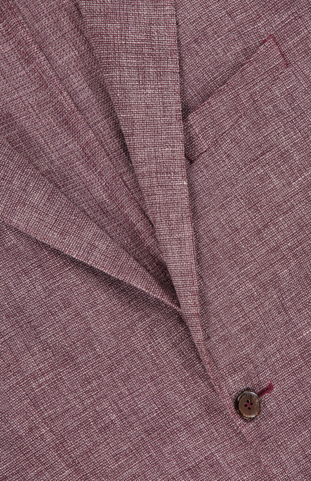 Close-up of the L.B.M. Wool Garment Dyed Sportcoat, made in Italy, featuring a textured lapel, chest pocket, brown button, and a visible weave pattern in the wool-linen blend fabric.